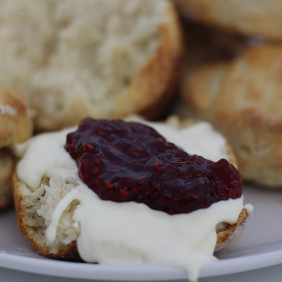 plate of scones with clotted cream and jam